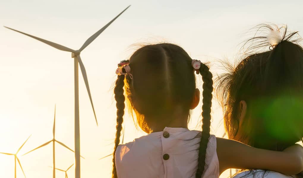 Mother and daughter looking at windfarm