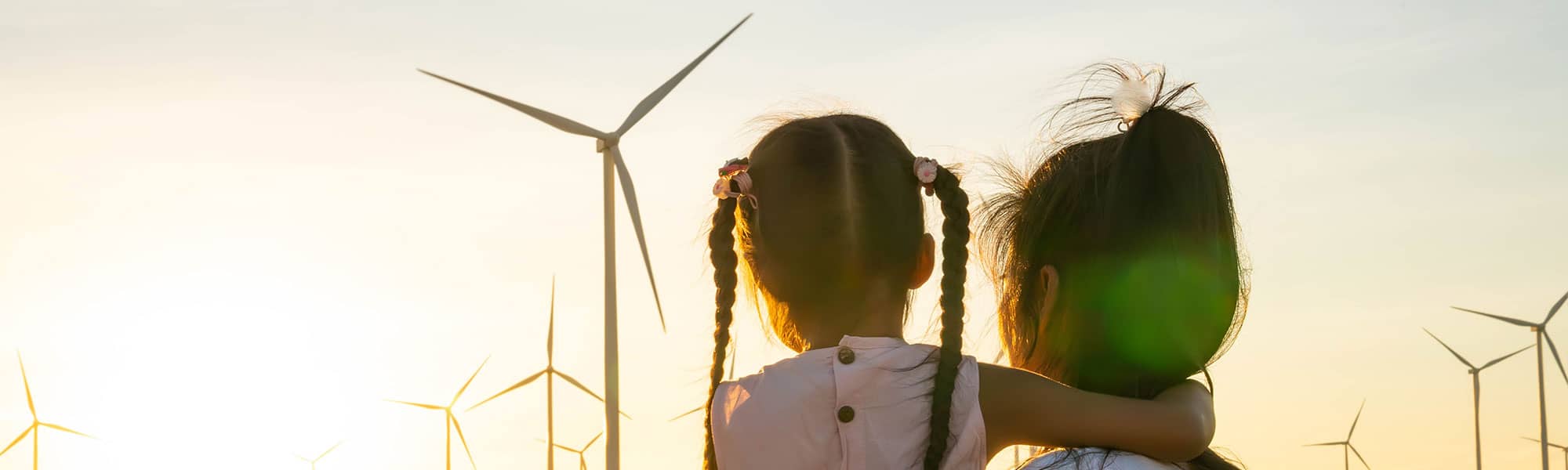 Mother and daughter looking at windfarm