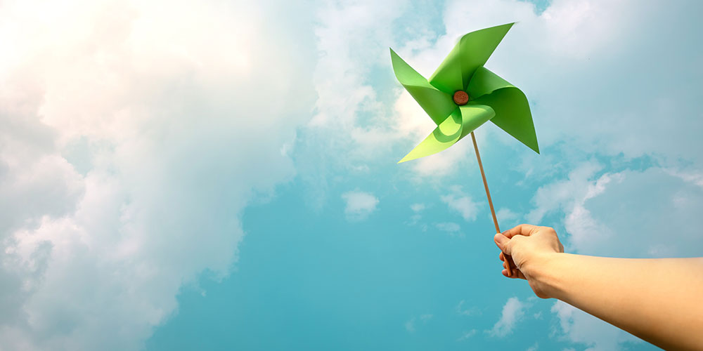 Paper windmill against blue sky