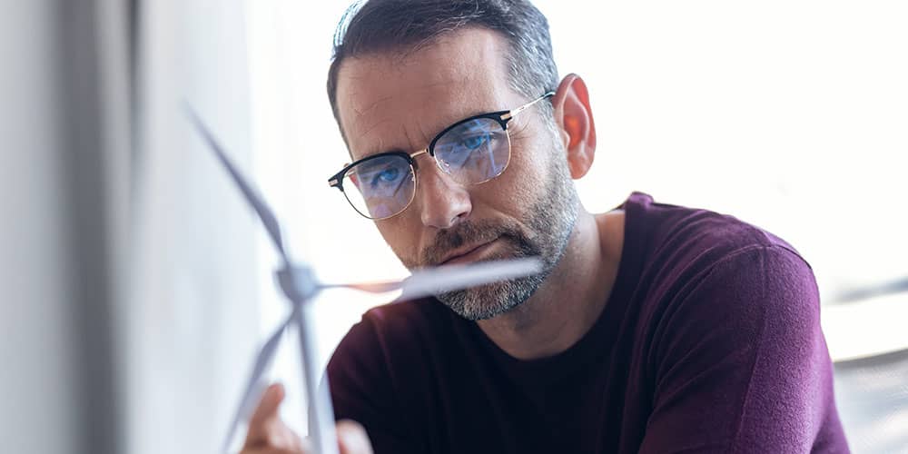 Man looking at model windmill